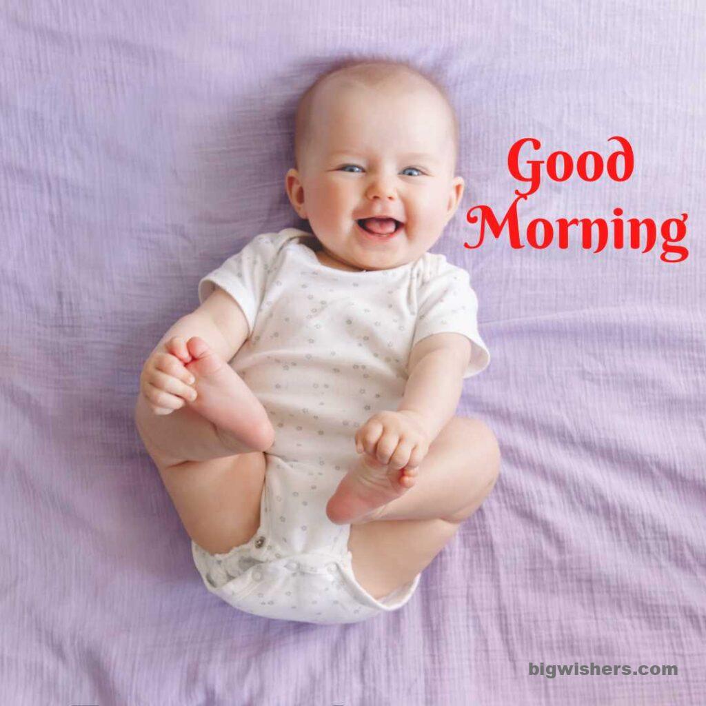 baby is laughing and hold the leg with good morning message