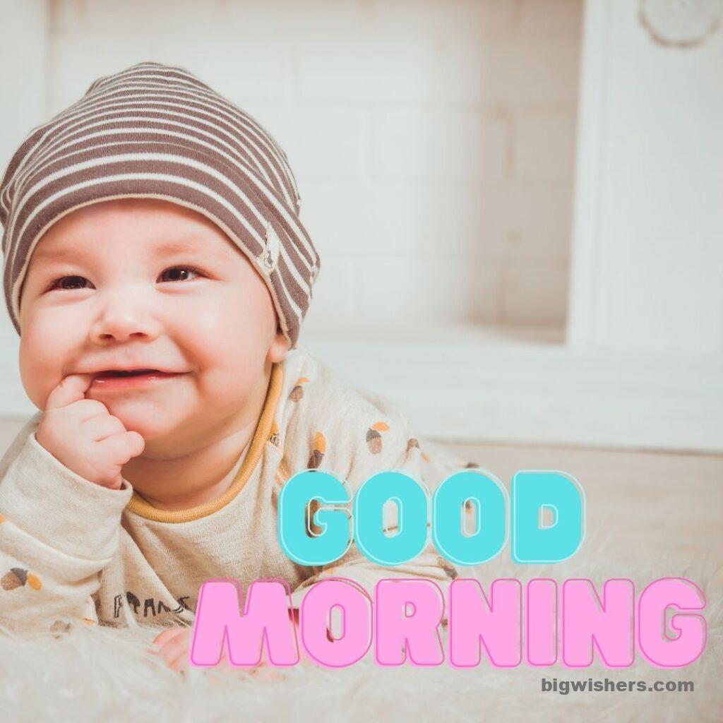 Cute baby with cap written good morning